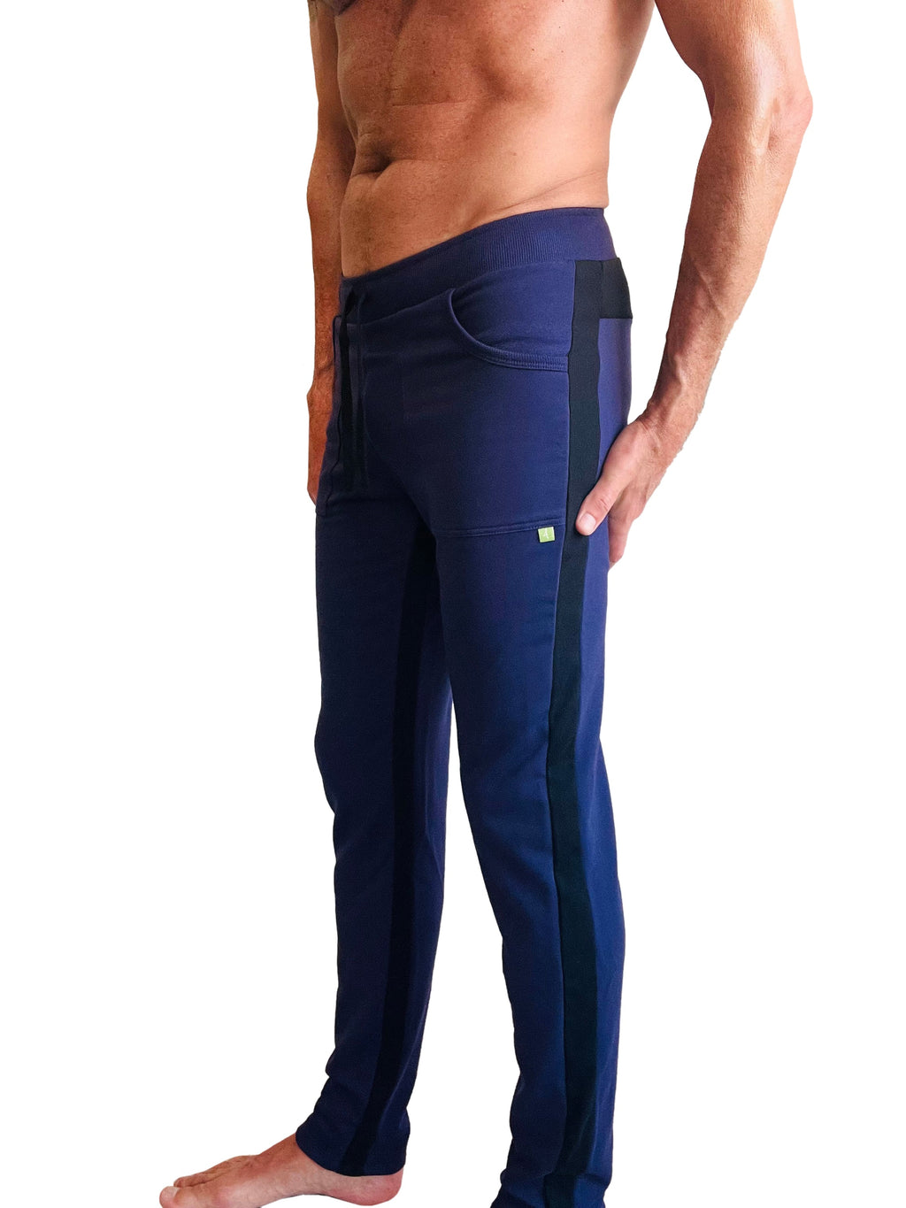 Navy blue eco-track and yoga sweat pants with black side stripes and a small green logo on the thigh