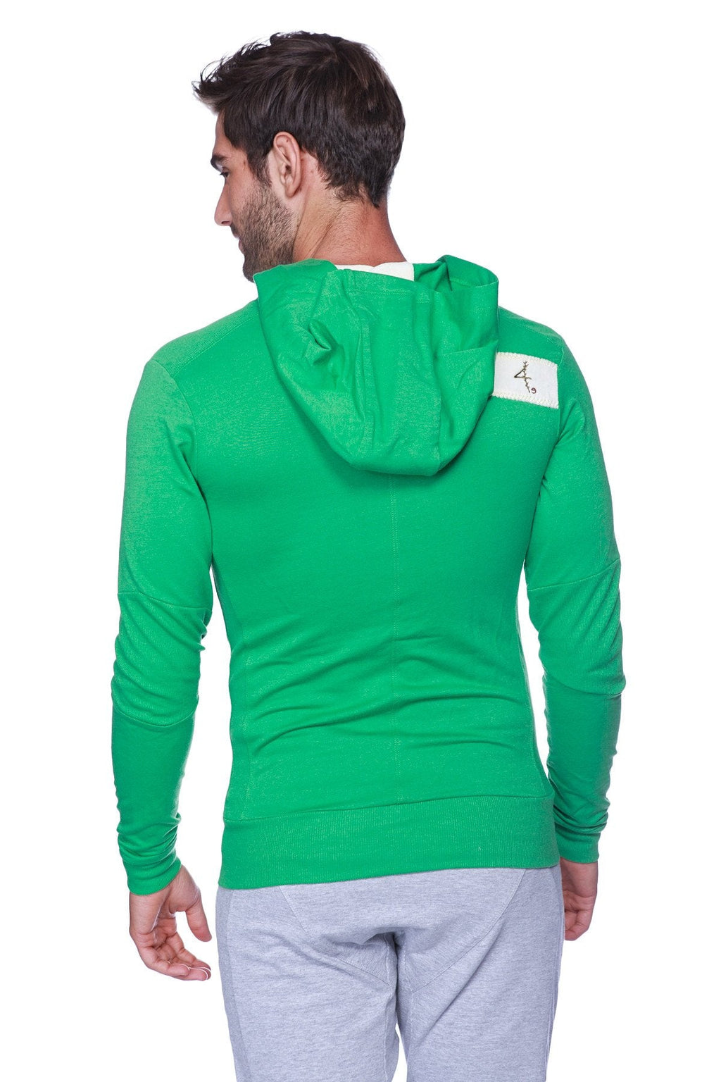 Back view of edge form-fit crossover yoga track performance hoodie in bamboo green with white rectangular patch