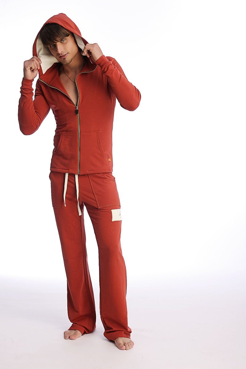 Red hooded zip-up sweatshirt and matching pants set in cinnabar for form-fit yoga and performance activities