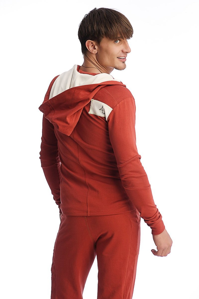 Back view of edge form-fit cinnabar red hoodie with white interior lining and small white patch on shoulder