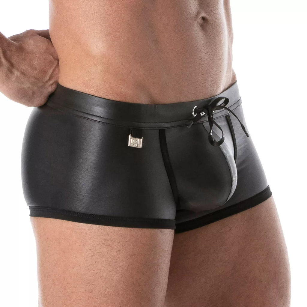 Black patent leather fetish swim trunks with sleek glossy finish and black drawstring waistband