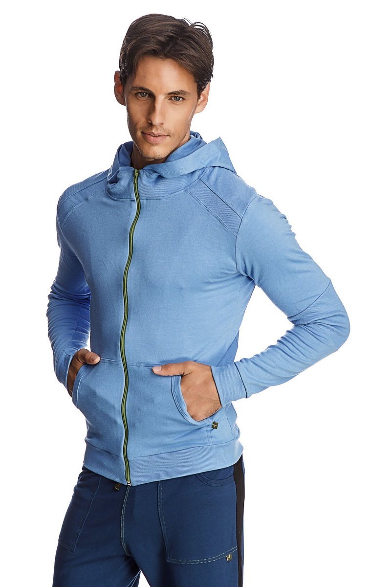 Light blue form-fit crossover yoga track performance hoodie with green zipper and textured shoulder panels