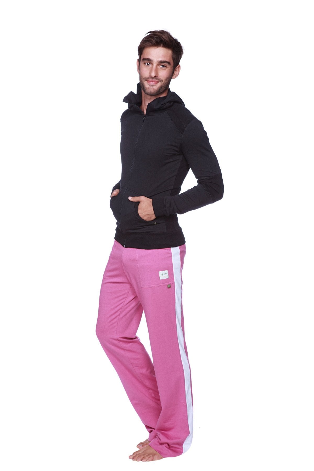 Pink athletic pants with white side stripe and logo patch paired with solid black form-fit crossover yoga track hoodie