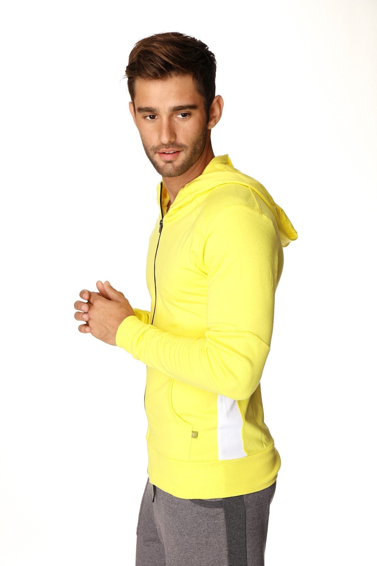Form-fit crossover yoga track performance hoodie in tropic yellow with white side panels and matching hood