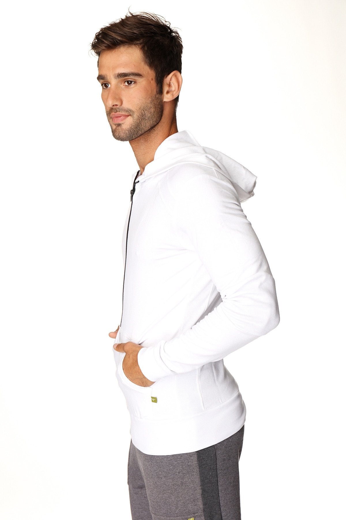 White form-fit crossover yoga track performance hoodie with black zipper and green logo on lower left side