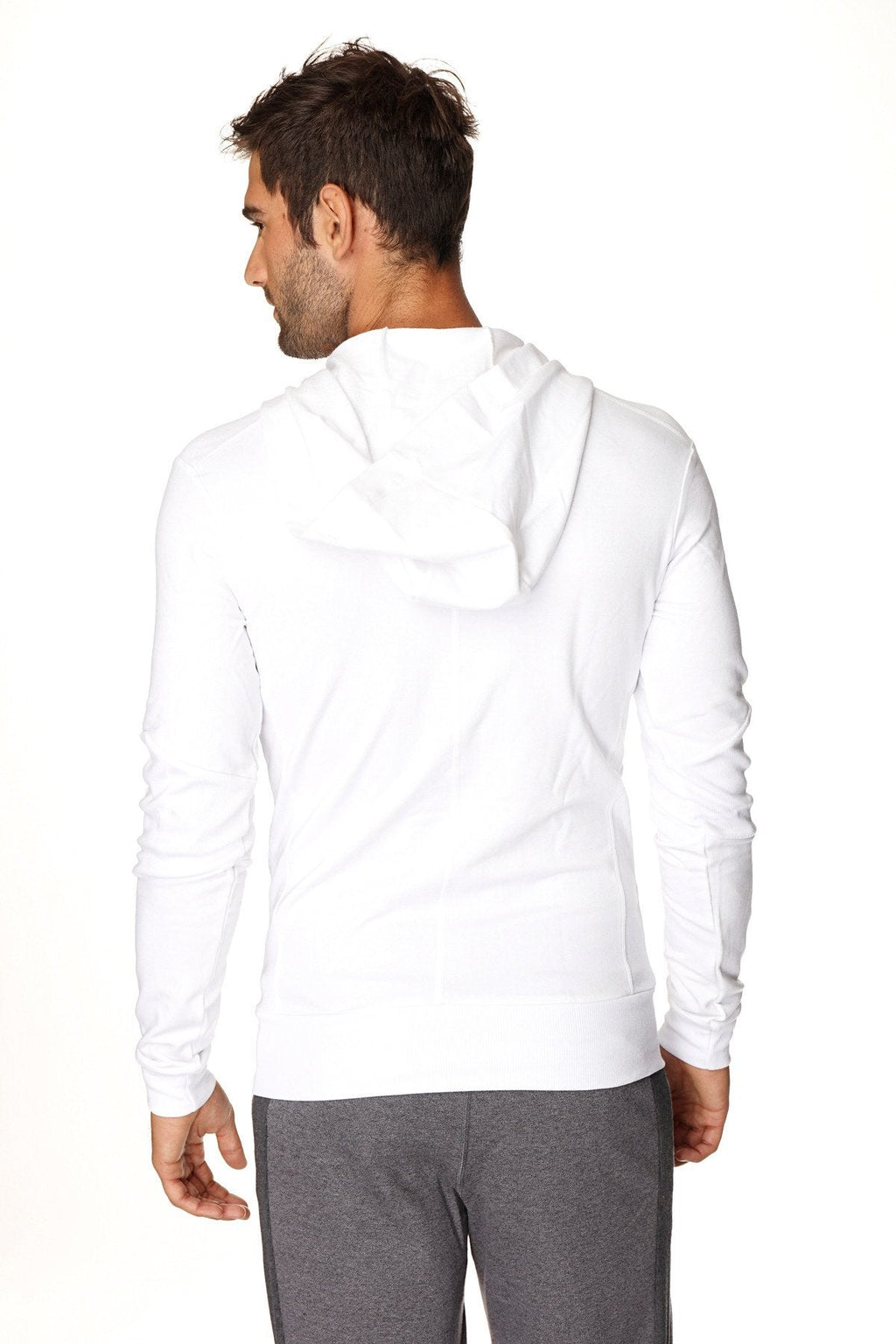 White long-sleeved form-fit crossover yoga track hoodie with soft smooth fabric and black zipper front closure