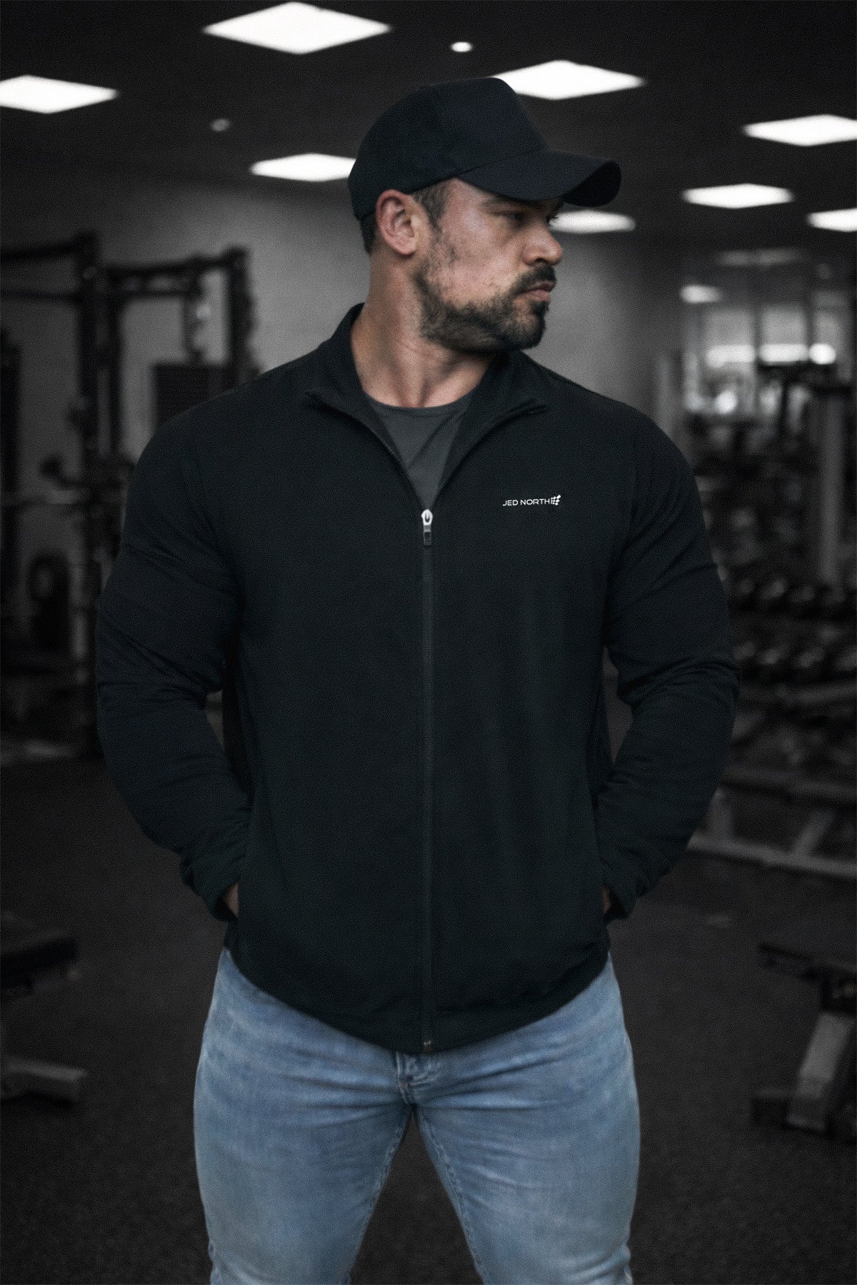 Full-zip training jacket in black with a subtle white logo on the left chest perfect for workouts