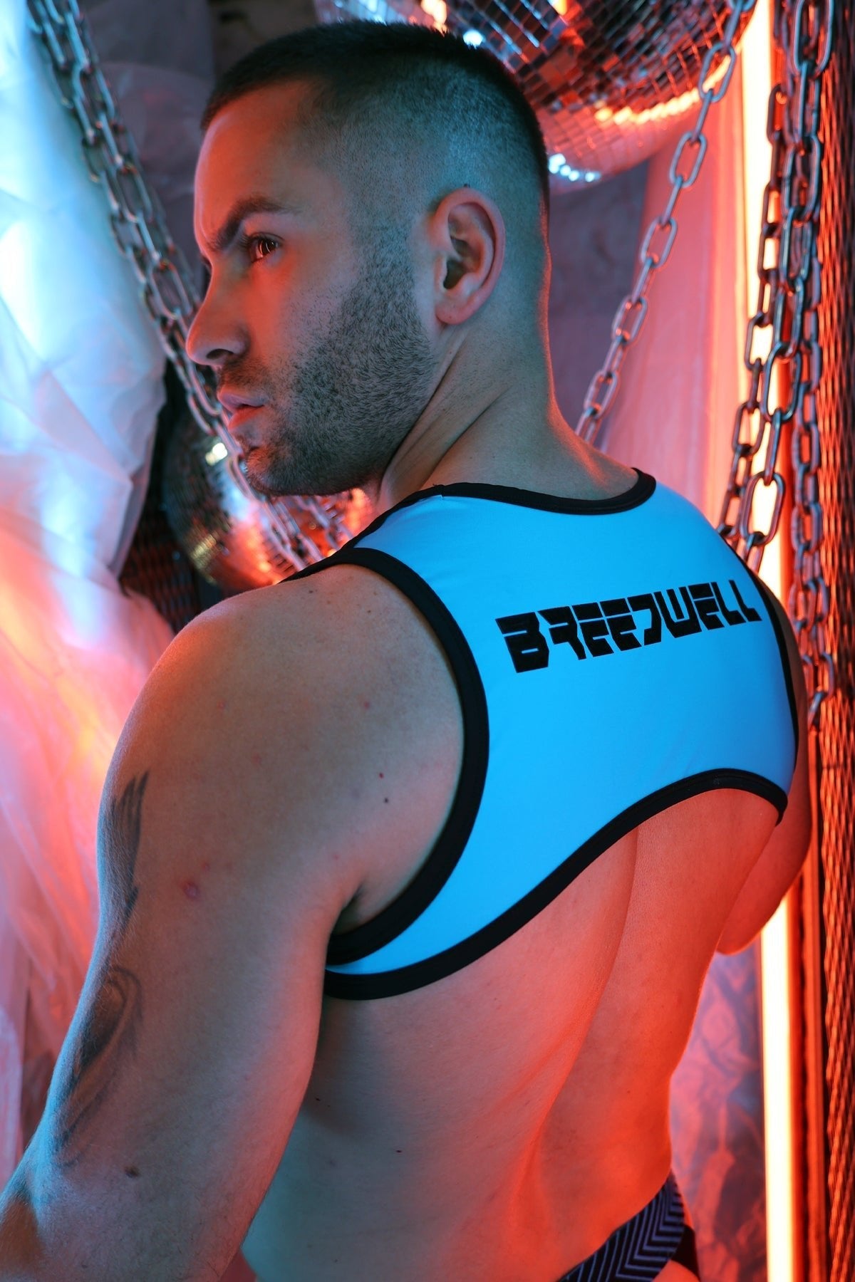 Back view of a bright blue black trimmed backless futura tank harness with bold brennell lettering on upper spine
