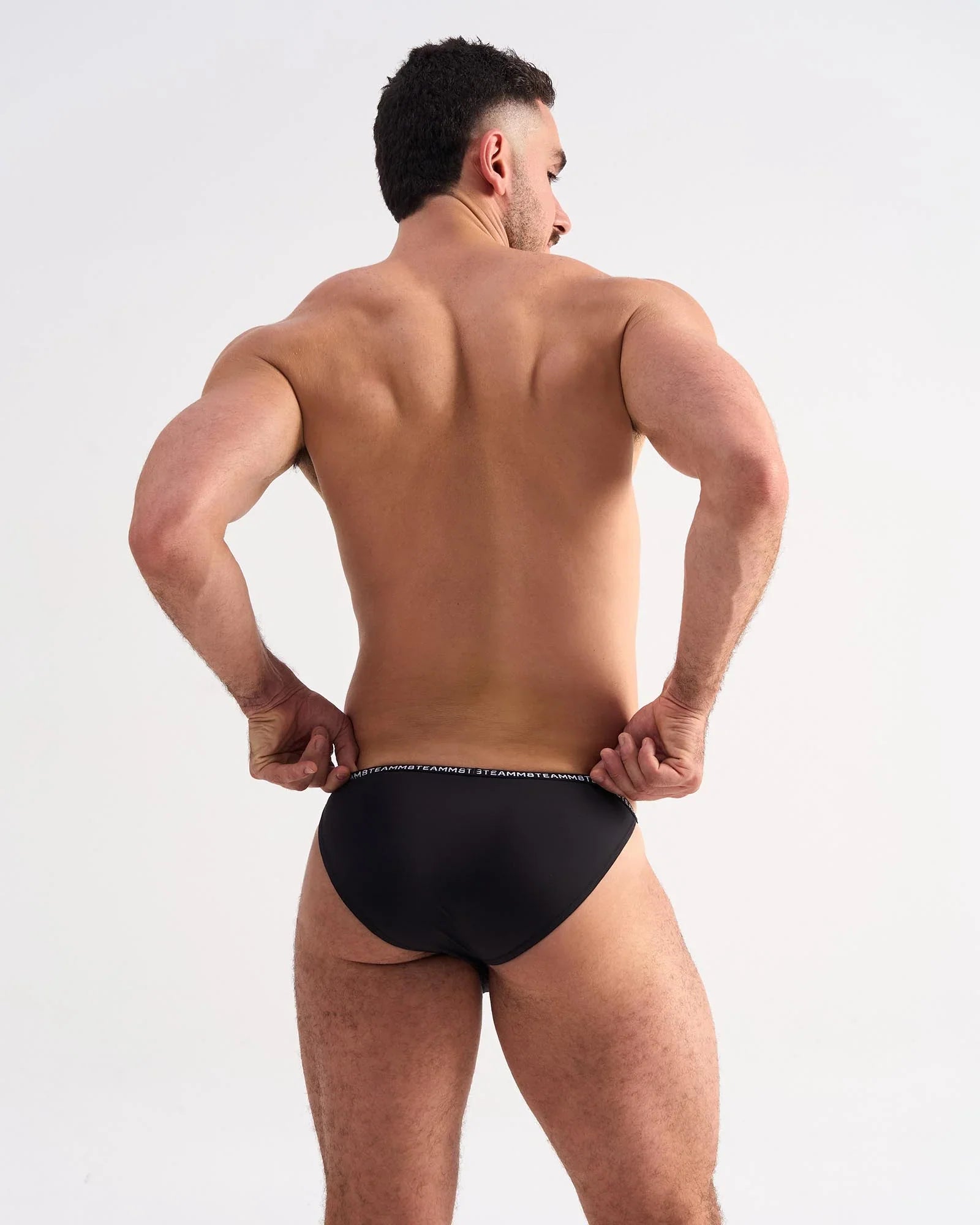 Black glide micro brief with subtle white logo trim on waistband made from soft breathable fabric