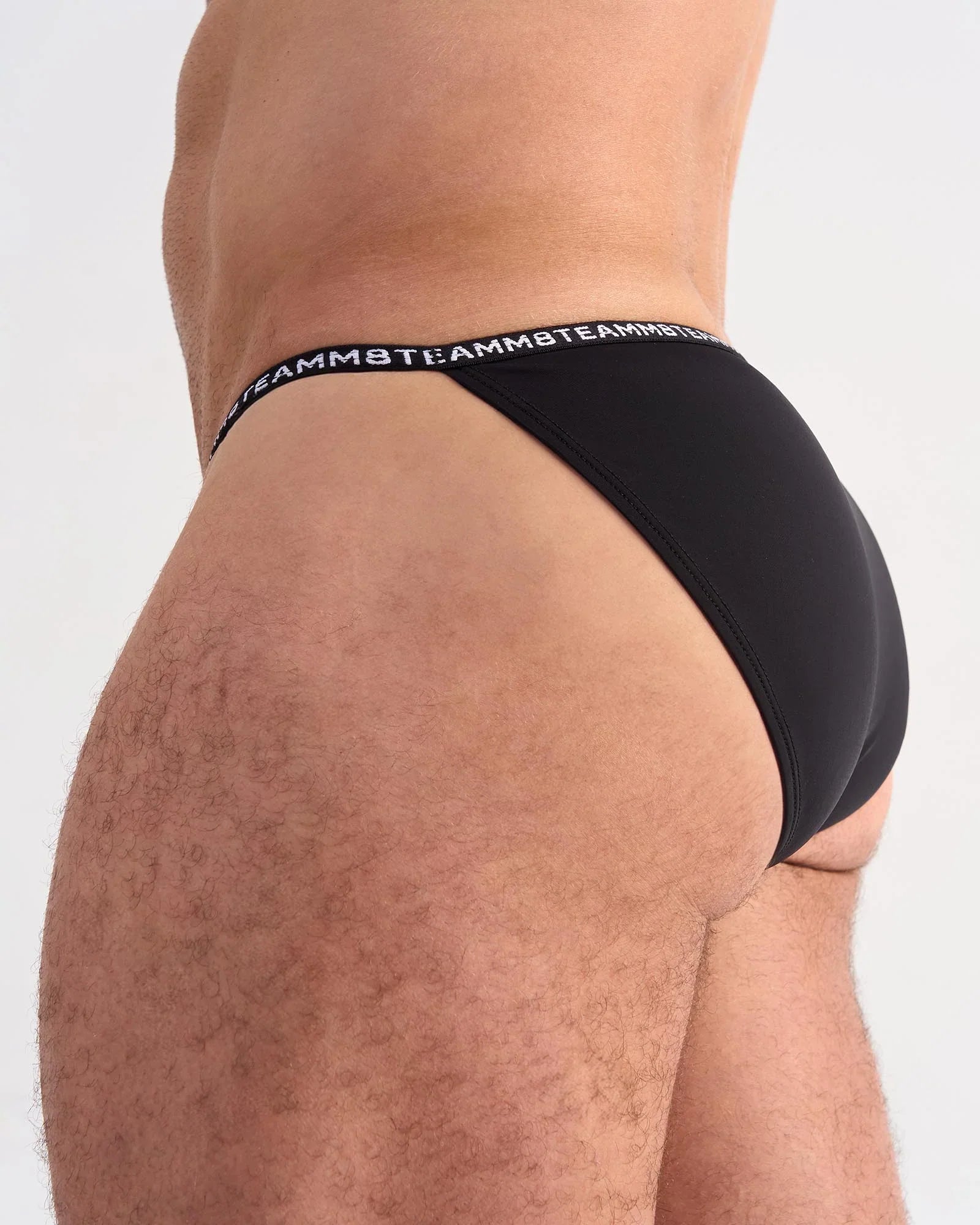Black glide micro brief with repeating white logo band on waistband made from soft stretch fabric