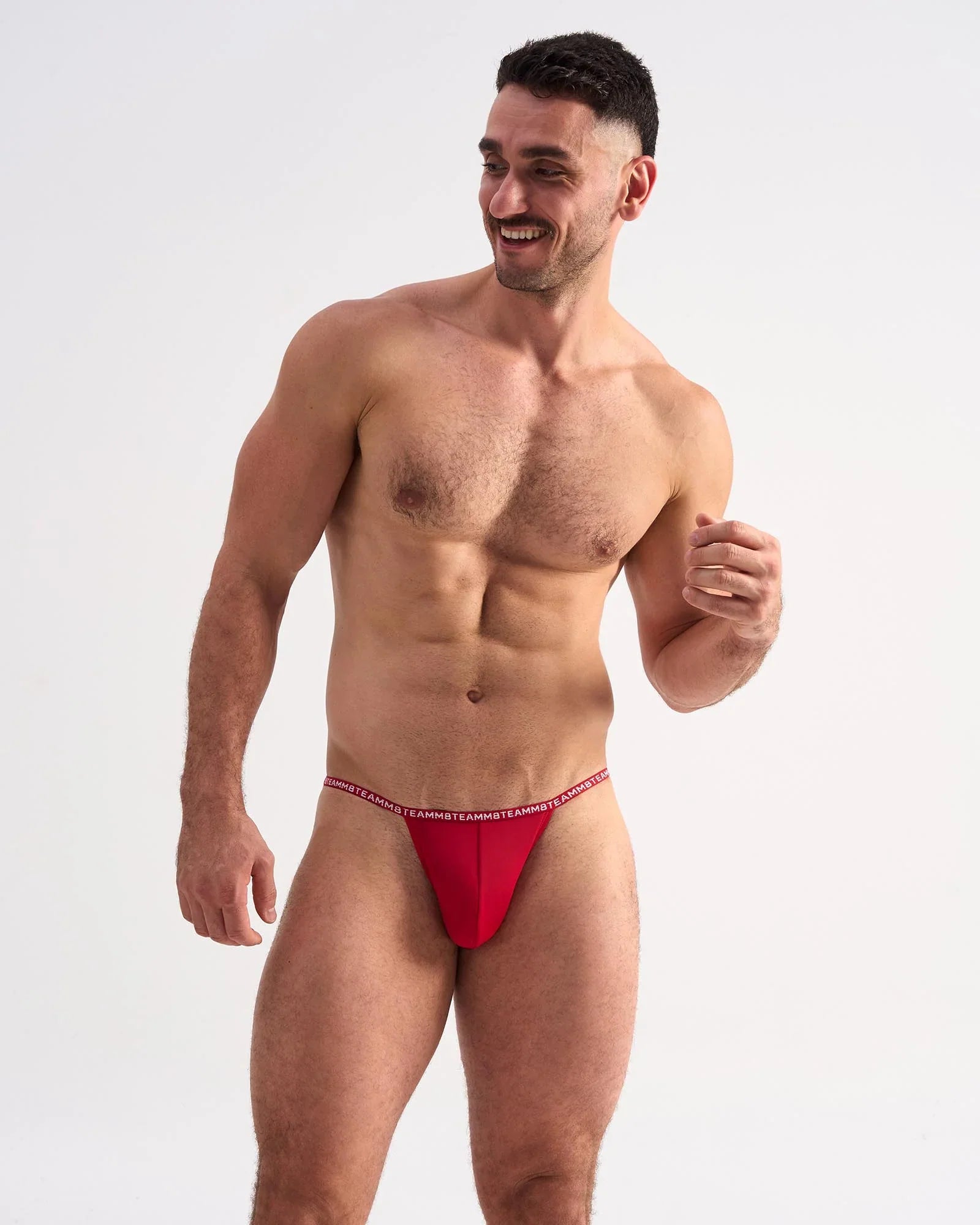 Red glide micro brief athletic briefs featuring a thin elastic waistband with repeating white text