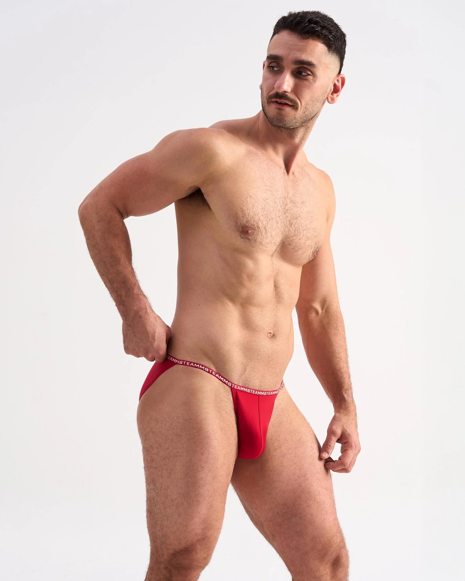 Red men’s glide micro brief with thin elastic waistband featuring white lettering for comfortable daily wear