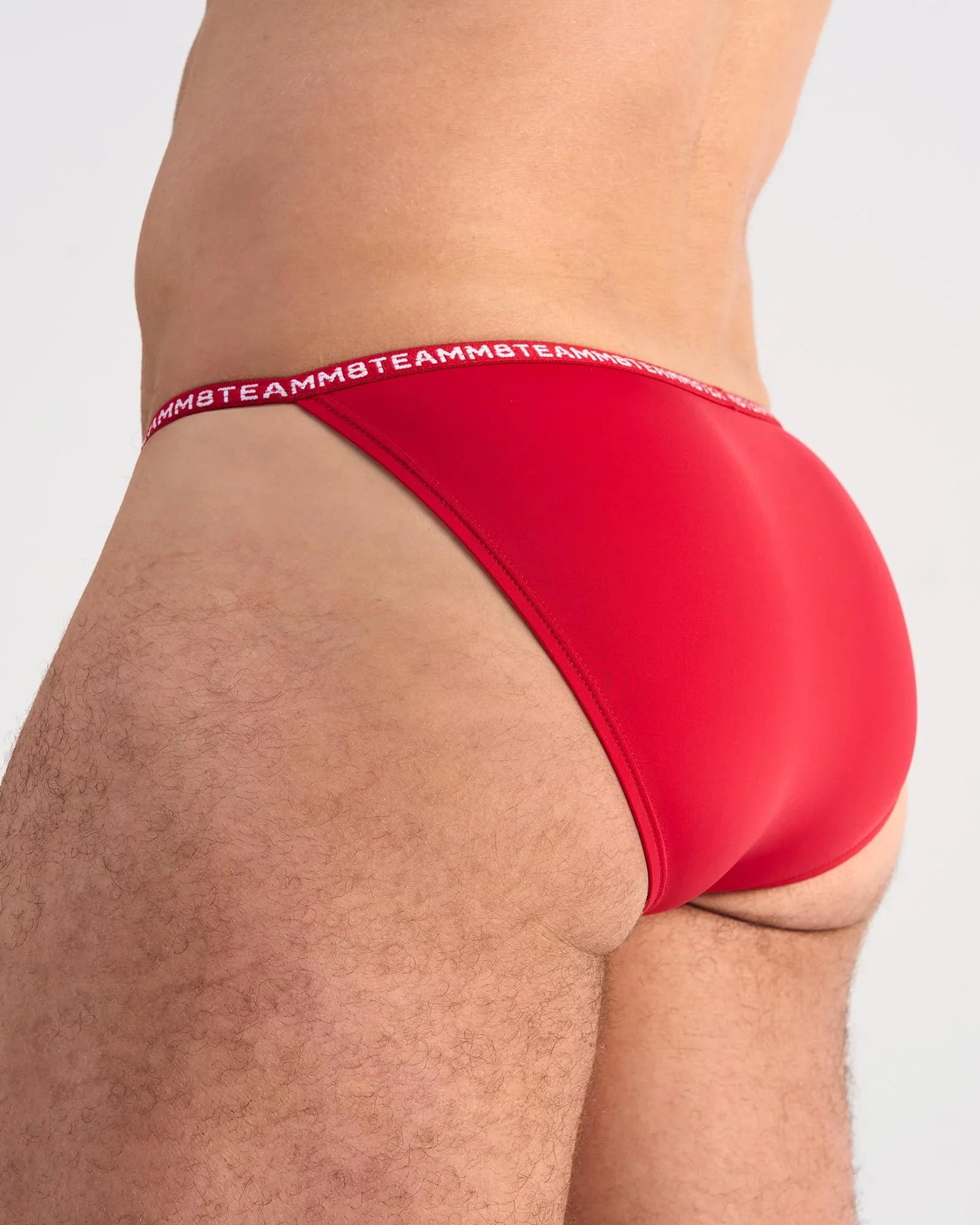 Red glide micro brief with white teammb logo waistband made from lightweight breathable fabric for active wear