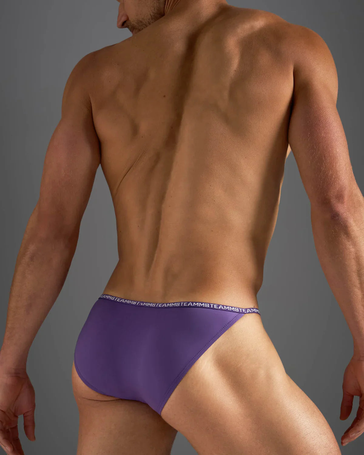 Purple glide micro brief athletic briefs with white repeating logo waistband designed for active wear