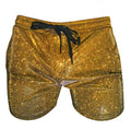 Gold glitter booty shorts with a black drawstring waistband made of sparkling fabric for festive wear
