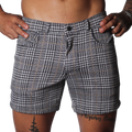 Black and white houndstooth print shorts with a subtle gold windowpane check, featuring a classic five-pocket design.