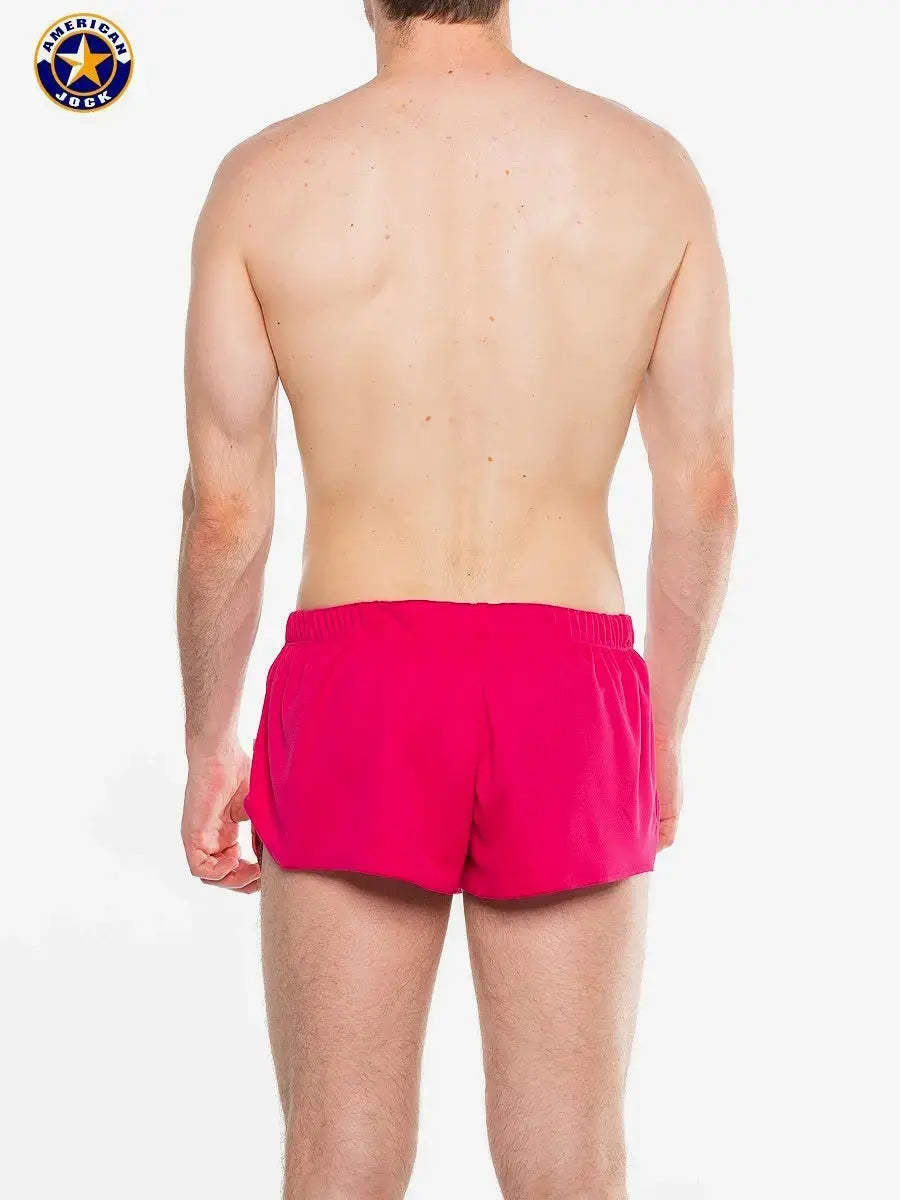 Men's running shorts in paradise pink featuring an elastic waistband shown from the back by AMERICAN JOCK.