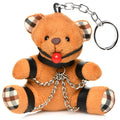 Orange plush gagged teddy bear keychain with black leather straps, plaid ears and paws, red ball nose, silver chains, and metal ring