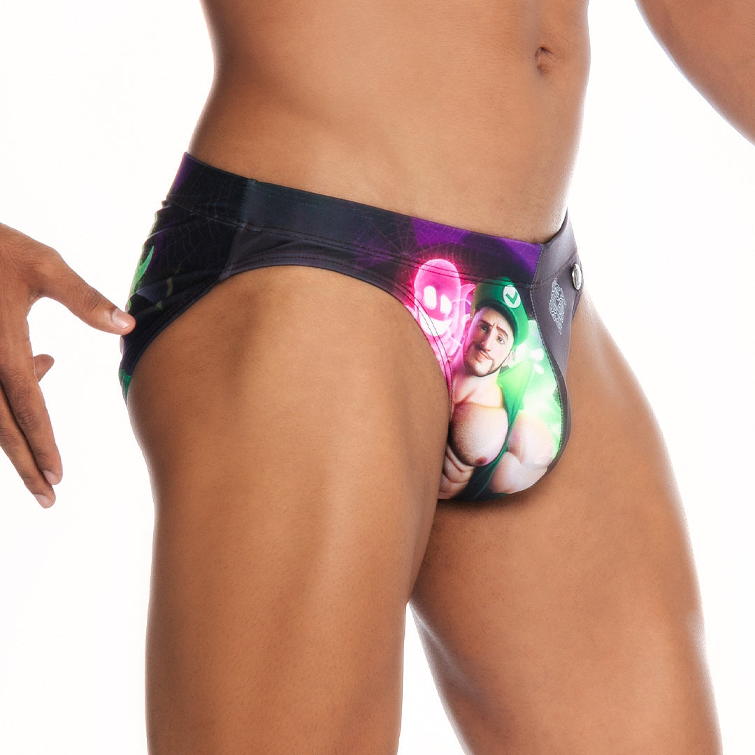 Black gigo super daddy purple swim brief with vibrant graphic of man in green holding glowing pink and neon green objects