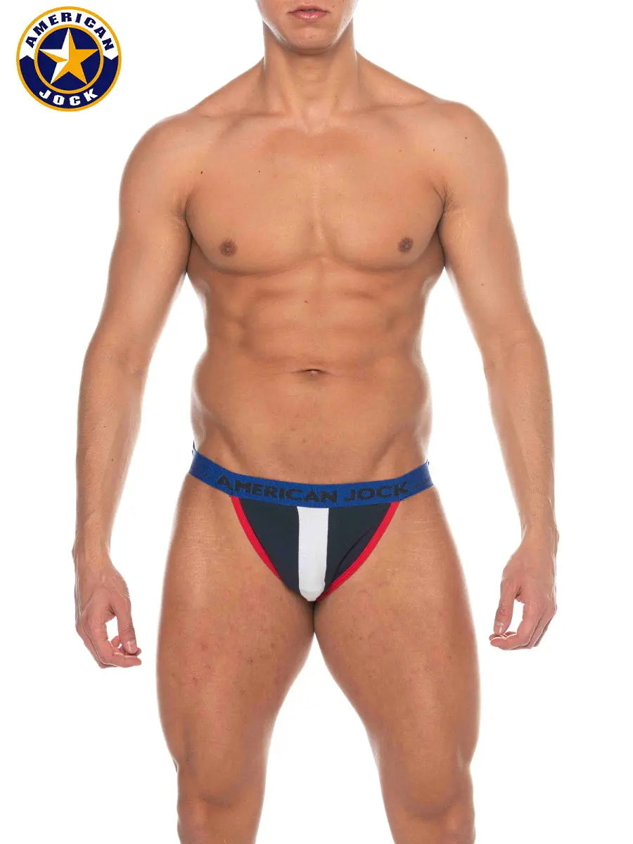 Navy jockstrap with red and white accents featuring a branded waistband modeled by a male figure by AMERICAN JOCK