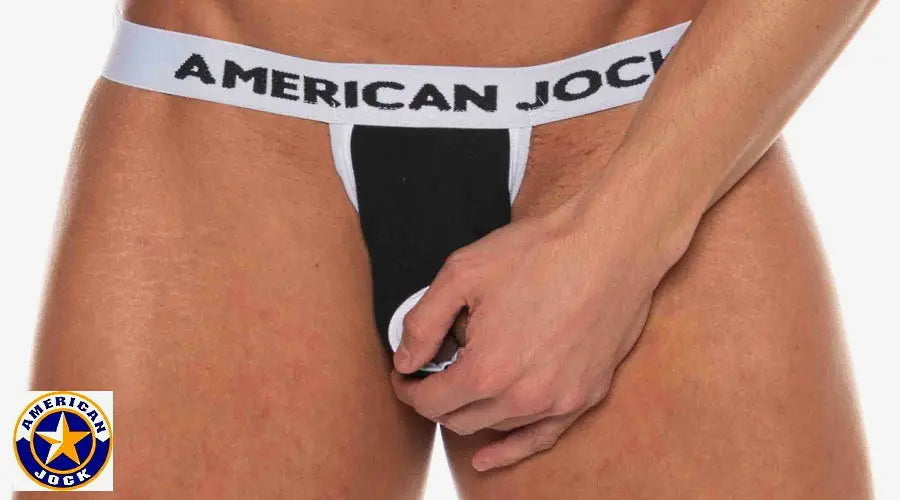 Black and white jockstrap with a wide waistband featuring 'AMERICAN JOCK' logo shown on a model.
