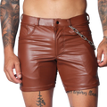Brown faux leather fitted shorts featuring a button fly, belt loops, and a detachable silver chain detail at the hip.