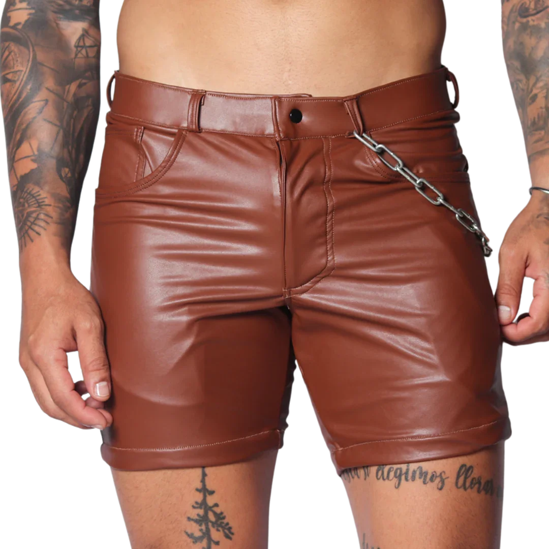 Brown faux leather fitted shorts featuring a button fly, belt loops, and a detachable silver chain detail at the hip.