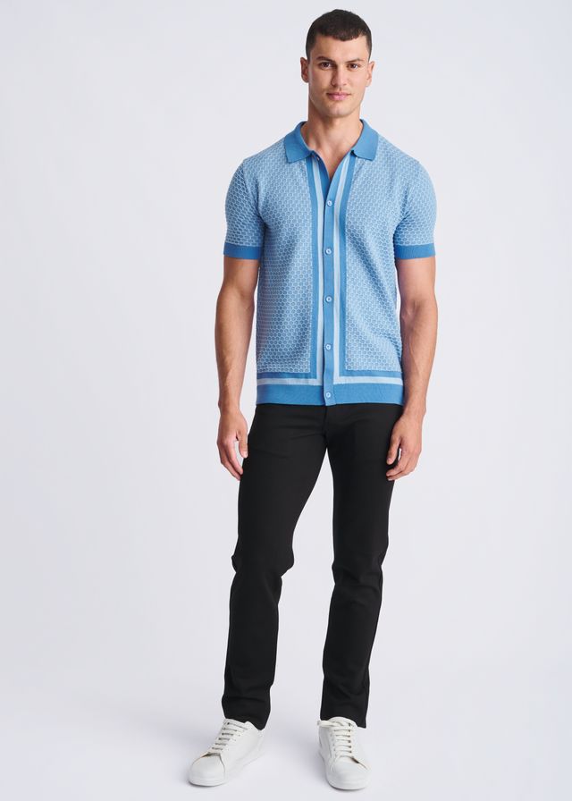 Light blue short-sleeved honeycomb textured knit polo shirt with geometric pattern and darker blue trim on collar and cuffs