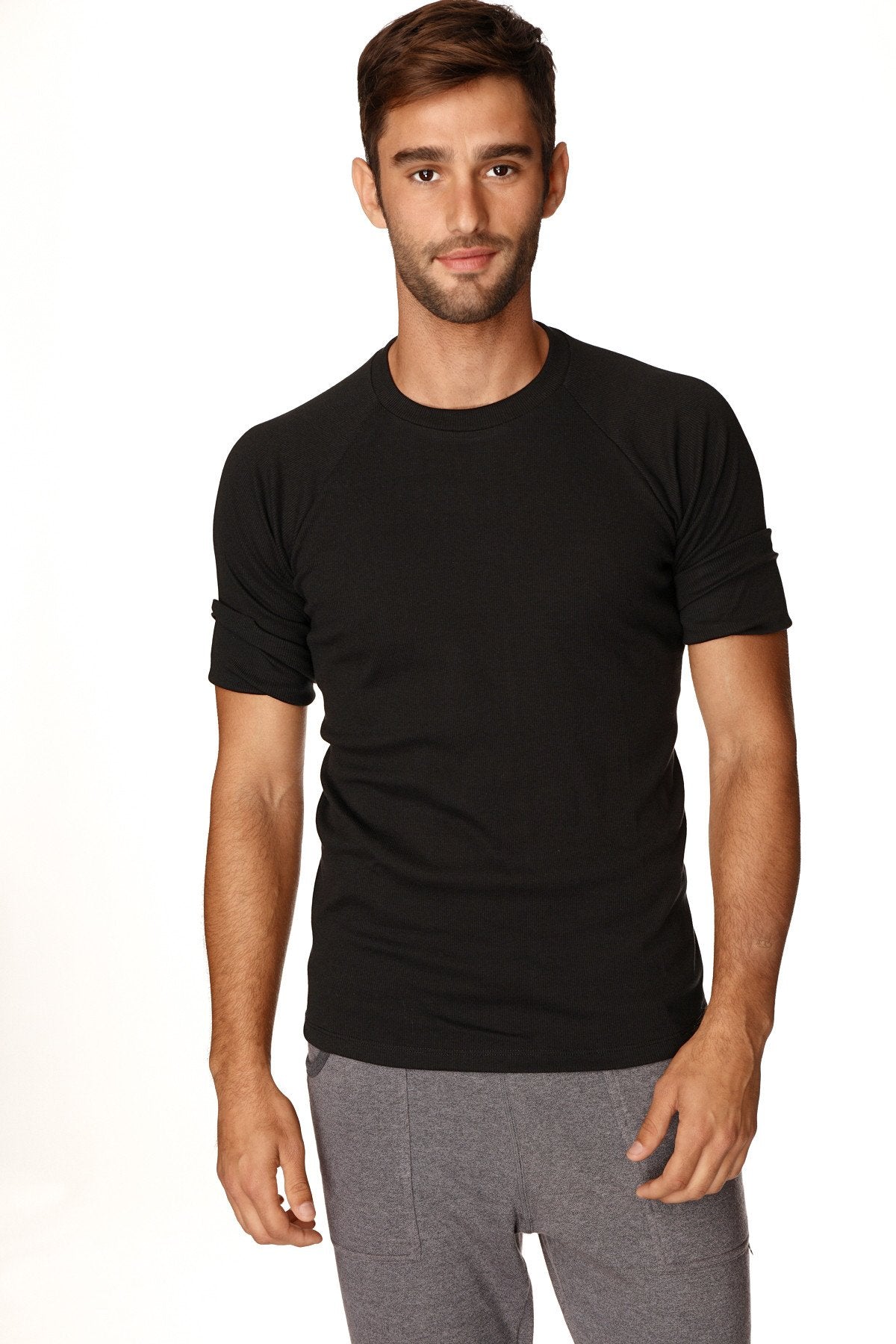 Black short-sleeved hybrid crew neck raglan tee with rolled-up sleeves made from breathable fabric