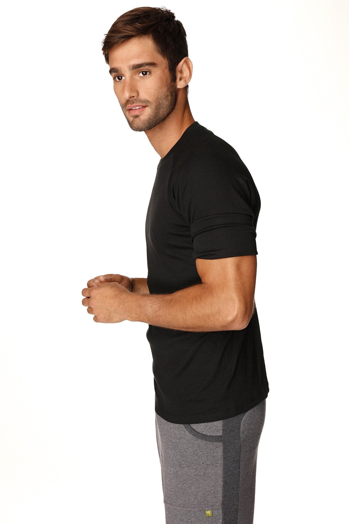 Black short-sleeved hybrid crew neck raglan tee with subtle ribbed texture for athletic wear