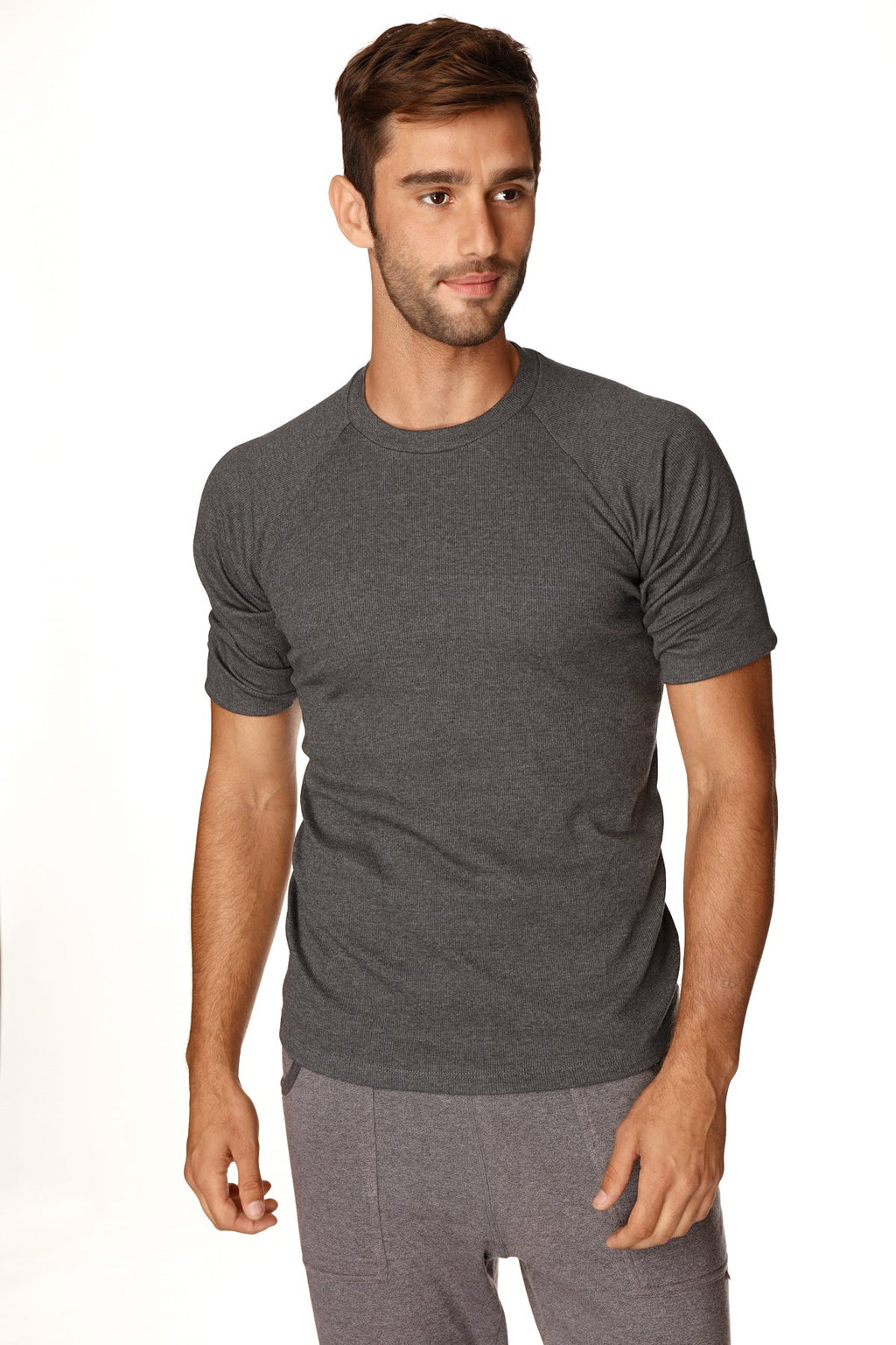 A dark heather gray short-sleeved hybrid crew neck raglan tee made of soft breathable fabric for casual wear