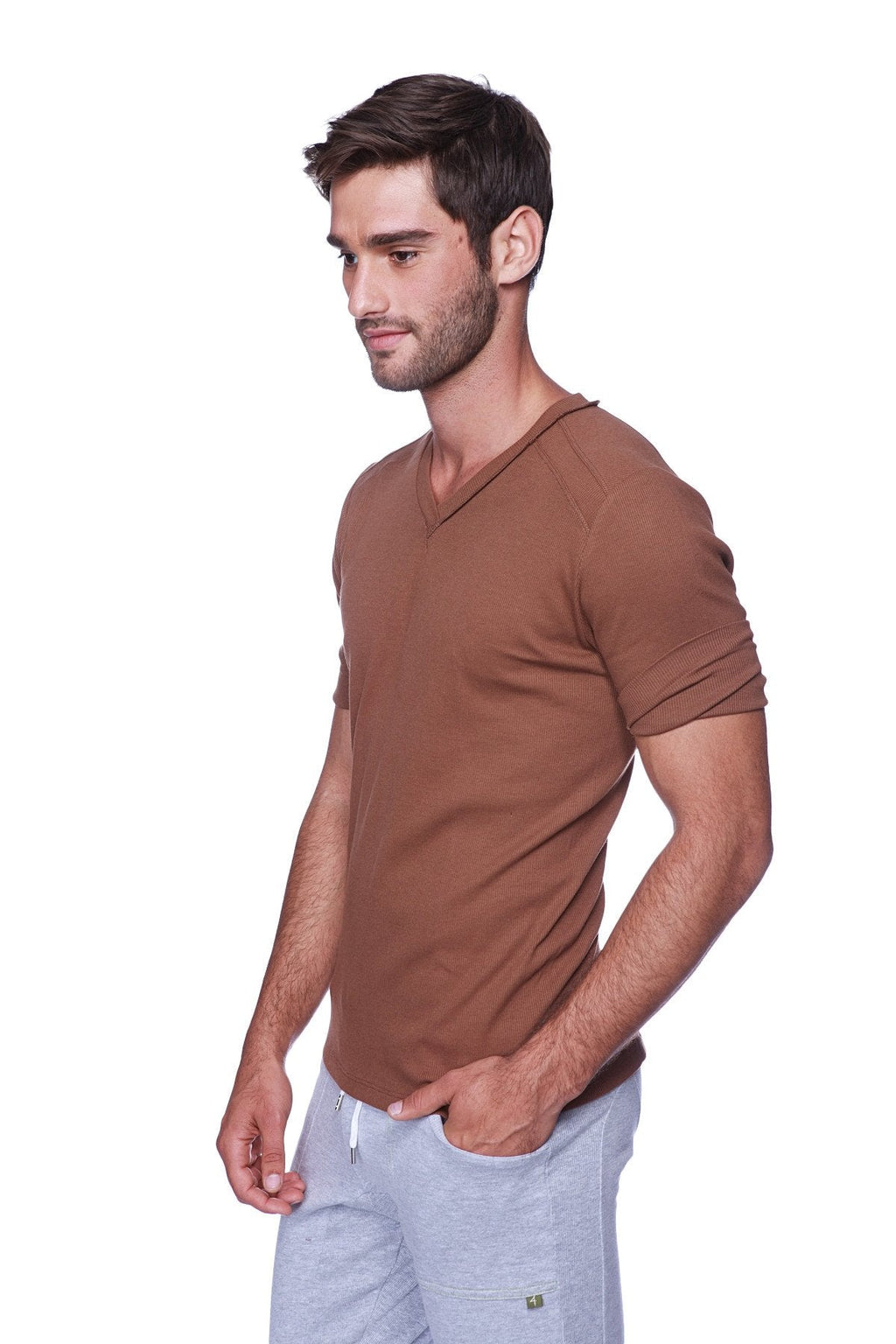 A man wearing a brown hybrid v-neck short-sleeved t-shirt in chocolate color made from soft material