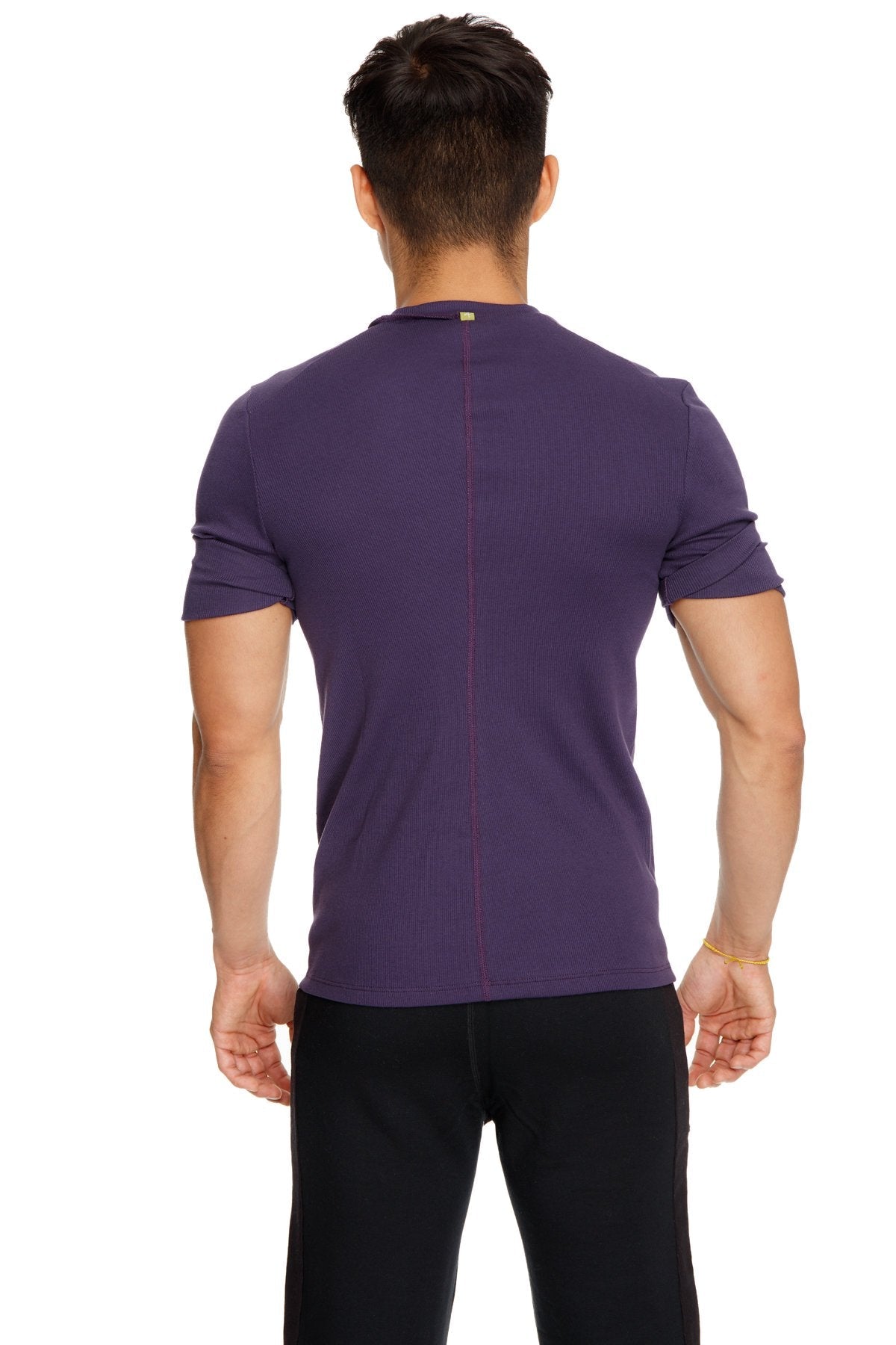 Back view of hybrid v neck purple short sleeved athletic tee with subtle vertical seam down the back