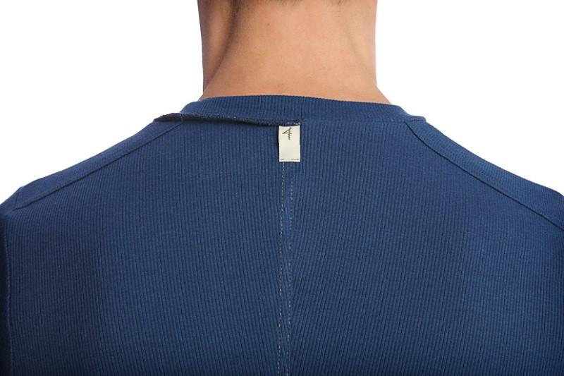 Blue ribbed knit hybrid v-neck shirt in royal with a small white tag at the neckline
