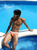 Orange and white icker sea contrast trim swim trunks with subtle logo on the side for beachwear and swimming