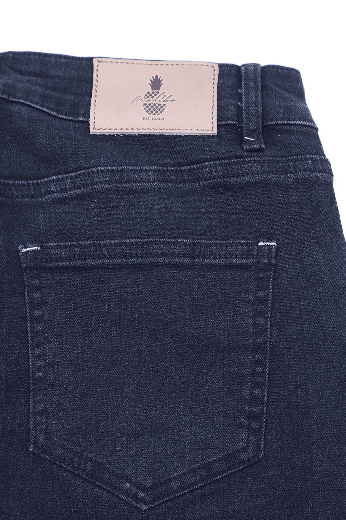 Dark blue denim jeans with beige leather patch featuring pineapple logo and pineapple text on the back side