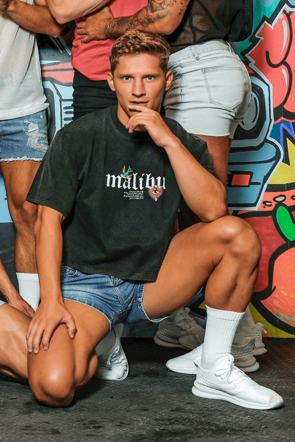 Black malibu t-shirt with white lettering and colorful logo graphic paired with in-your-dreams true blue denim short shorts