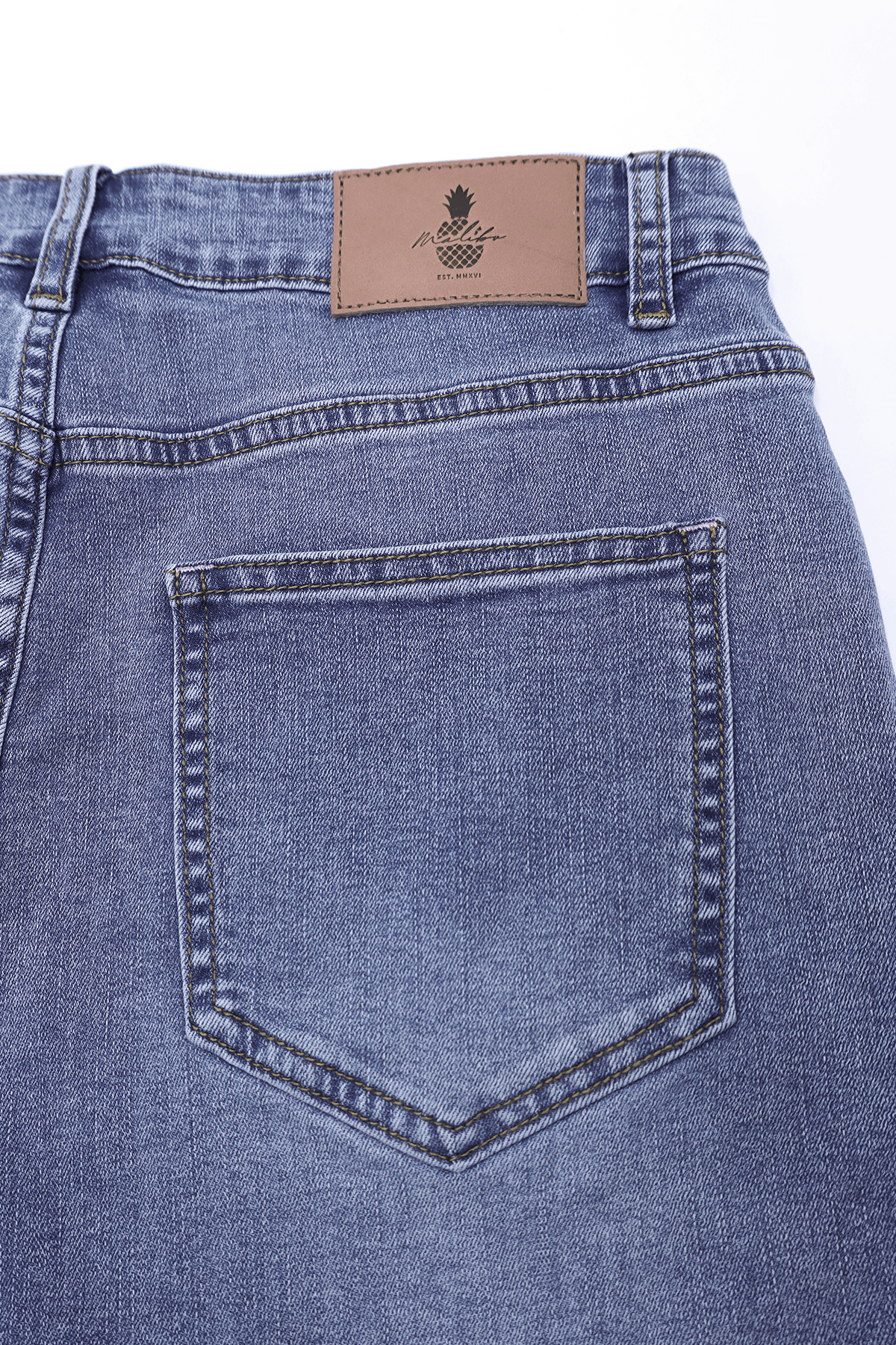 Blue denim in-your-dreams 3.5 inch short shorts with brown leather patch featuring pineapple logo and brand name on back
