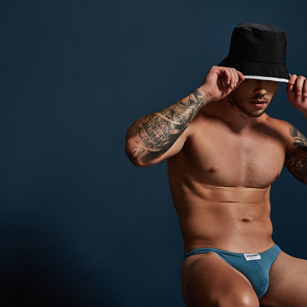 Blue textured Intymen INK017 thong briefs with a white brand tag made for comfortable everyday wear