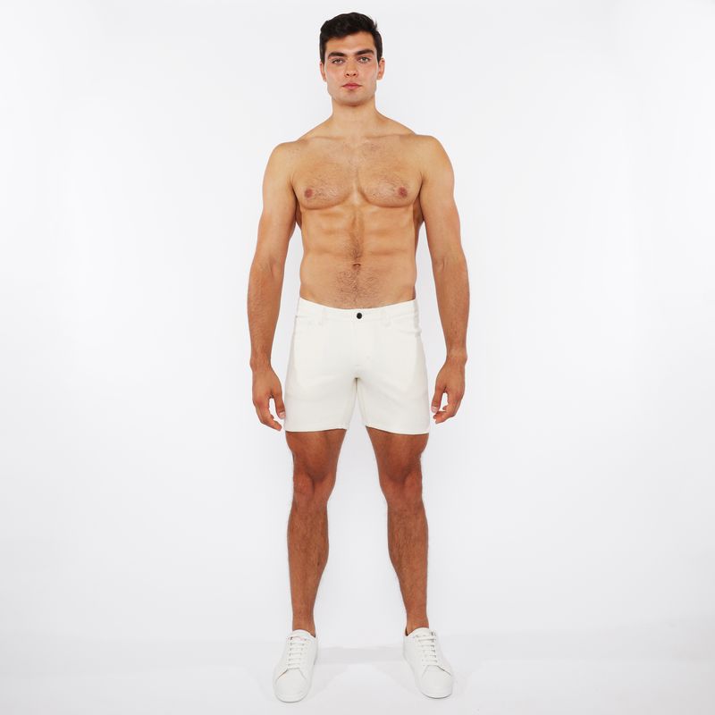 White jaquard stretch knit chino shorts with a sleek minimalist design and a single black button at the waistband