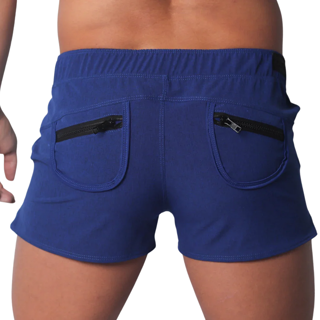 Royal blue short-length men’s athletic shorts with an elastic waistband and two back pockets featuring black zippers.