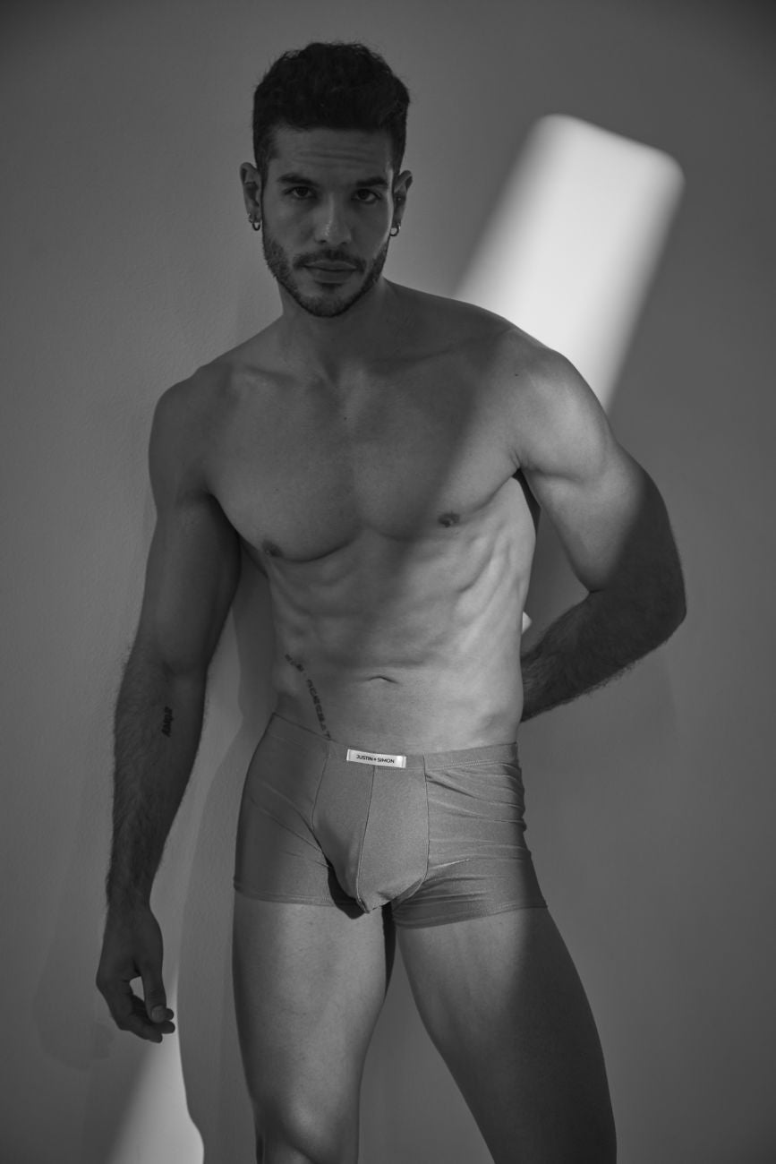 A man wearing light-colored form-fitting calvin klein classic boxer underwear in metal green color with visible waistband label