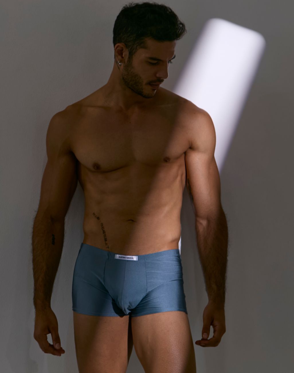 Blue cotton briefs with a white brand label at the waistband from justin simon xsj08 classic boxer metal green collection