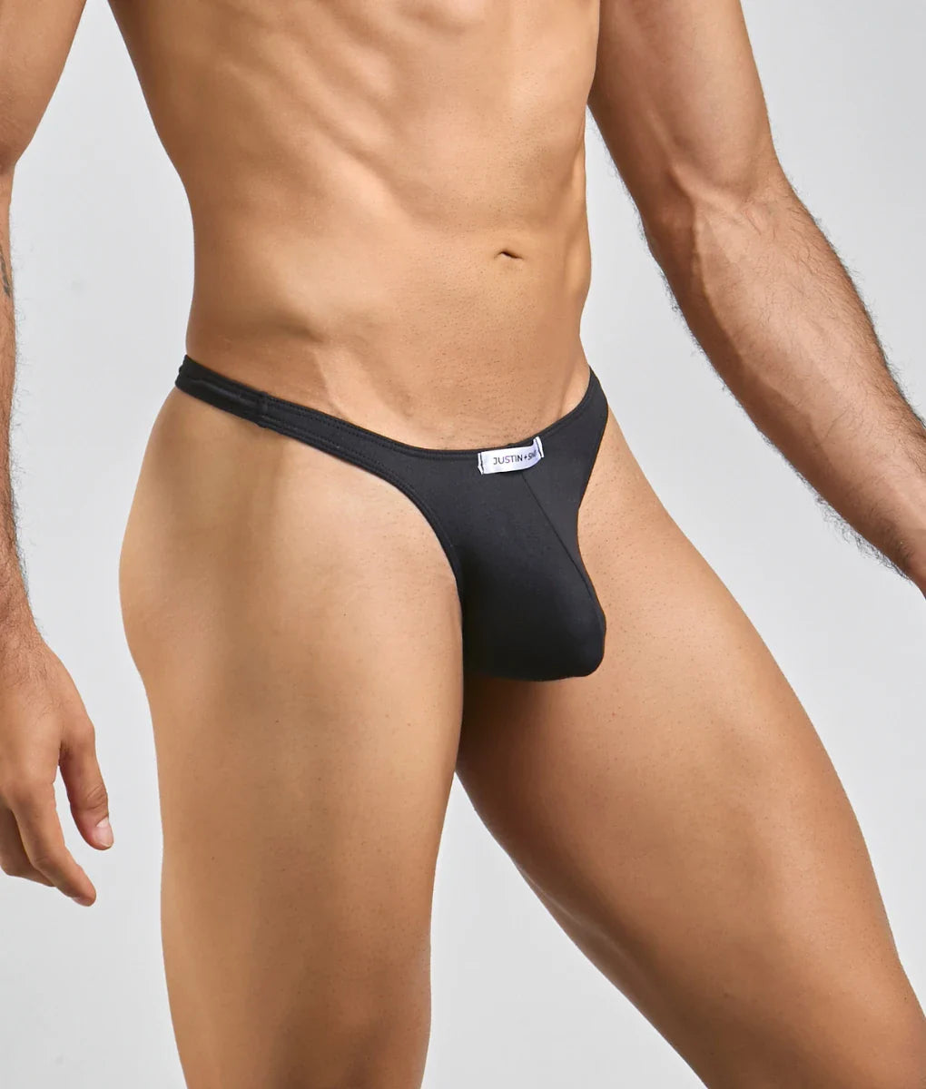 Black justbronze thong made of smooth peachskin fabric with sleek design and minimalistic waistband shown from back