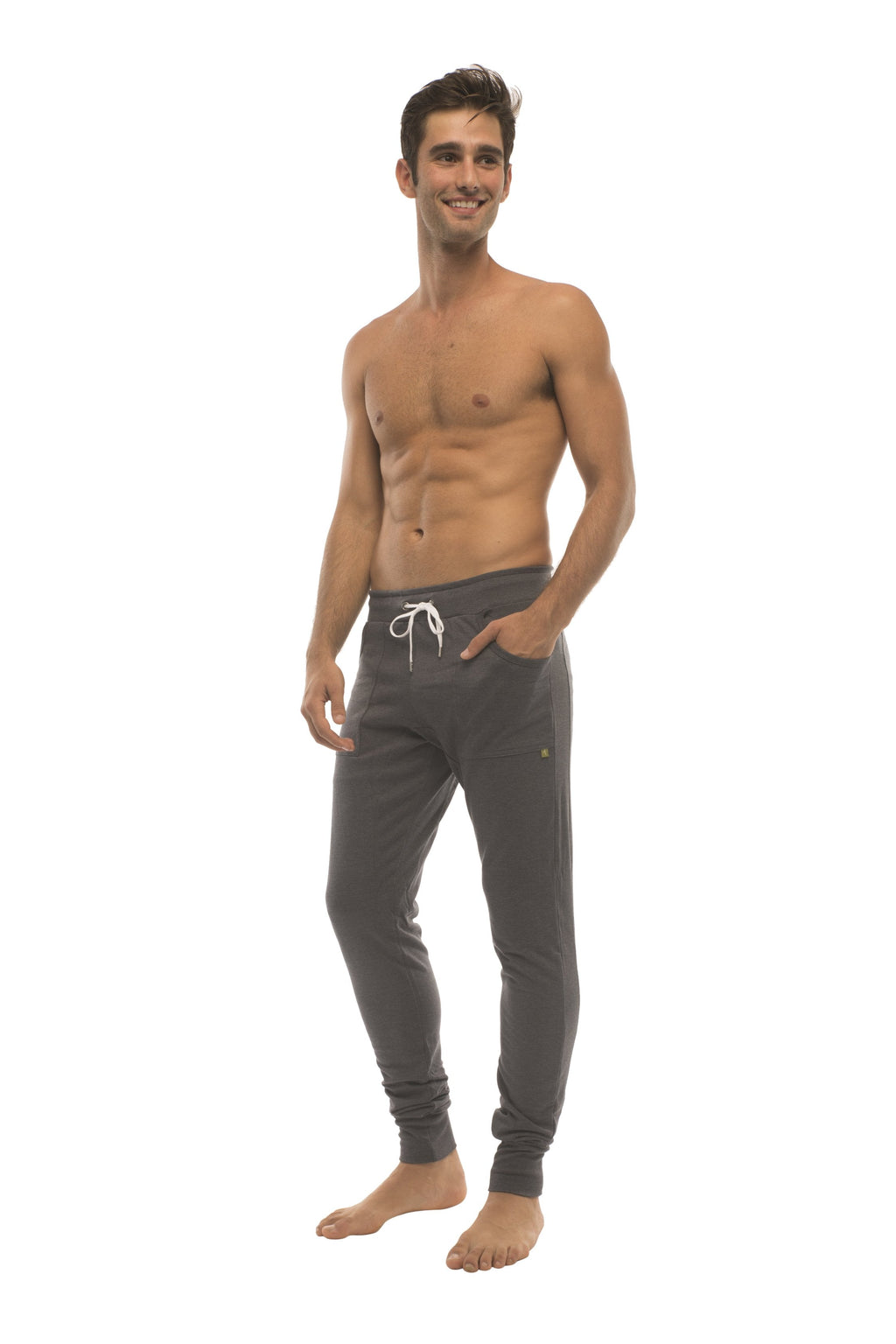 Long cuffed charcoal jogger and yoga sweat pants with white drawstrings and a small gold logo on the left thigh