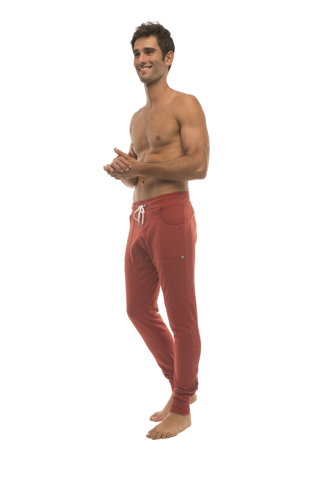 Long cuffed joggers in cinnabar red with white drawstring and side pockets perfect for yoga and athletic wear