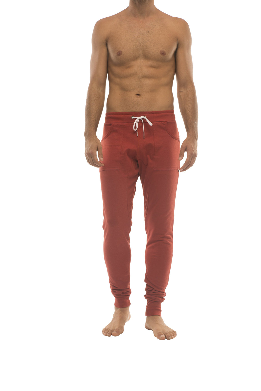 Red long cuffed jogger and yoga sweat pants in cinnabar with white drawstring waistband and elastic cuffs