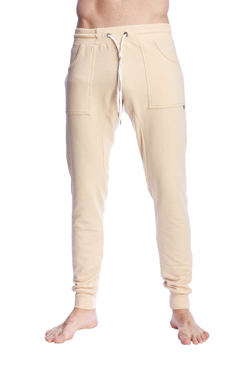 Long cuffed sand beige jogger and yoga sweat pants with drawstring waist and side pockets in cream color