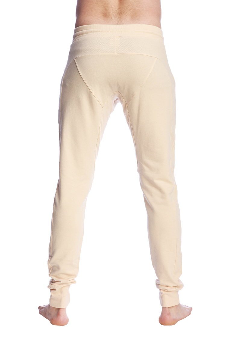 Cream-colored stretchy long cuffed jogger and yoga sweat pants with tapered fit and rolled cuffs in sand beige