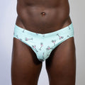 Mint green martini swim brief with playful pink martini glass pattern outlined in black perfect for swimwear